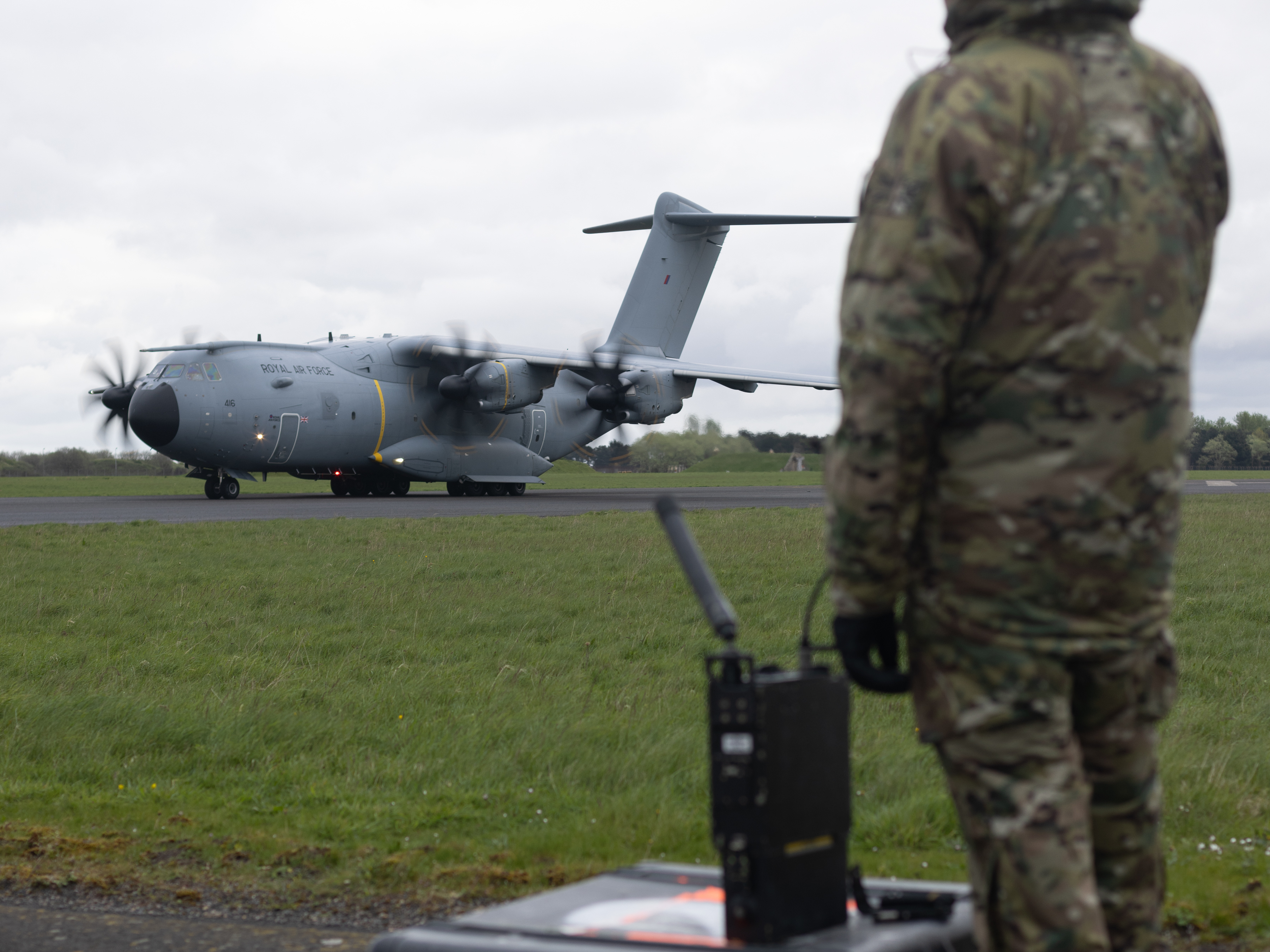 Photo: Tactical Air Traffic Control operative watches an Atlas C Mk.1 aircraft taxiing by.